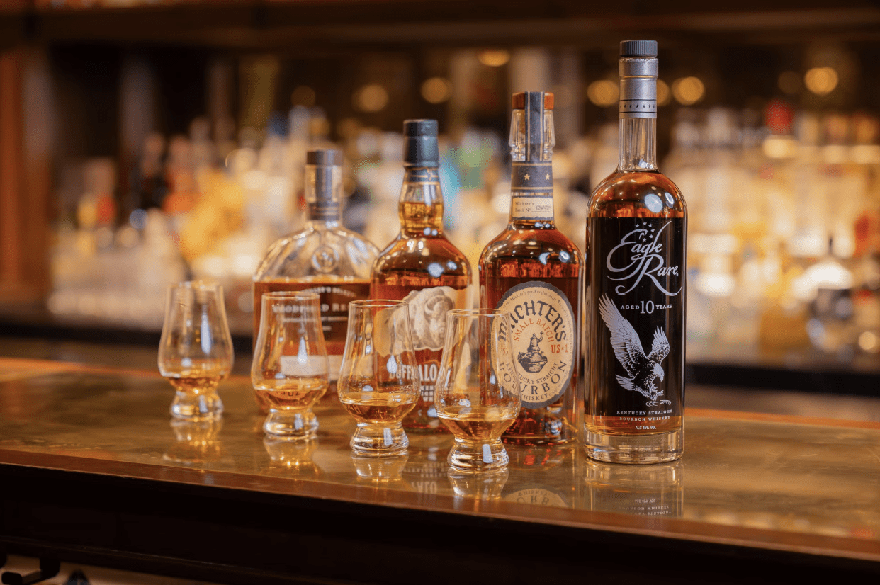 Eagle Rare Bourbon lined up with other Whiskey collections on a bar