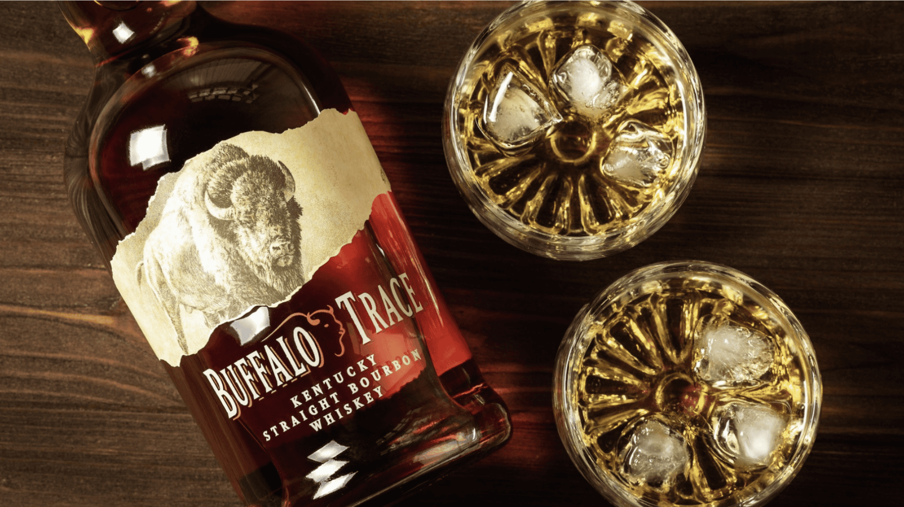 Buffalo Trace Kentucky Straight Bourbon Whiskey bottle beside two glasses of bourbon
