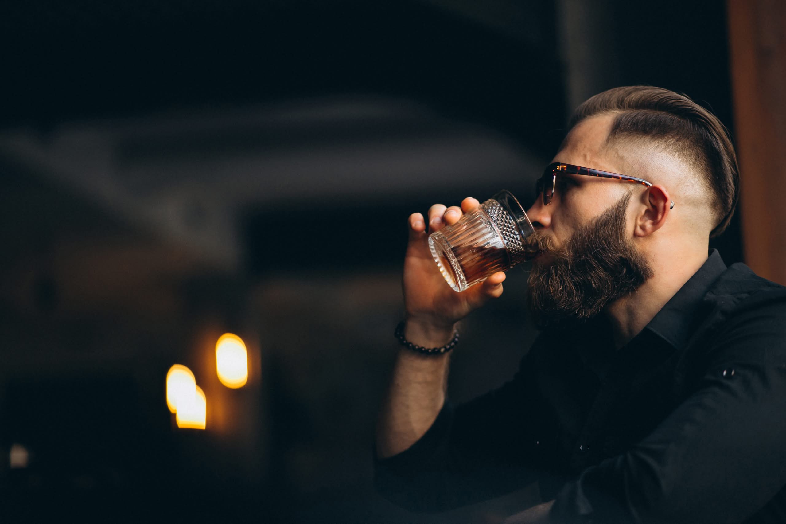 bearded man drinking Blanton’s Original Single Barrel in a bar